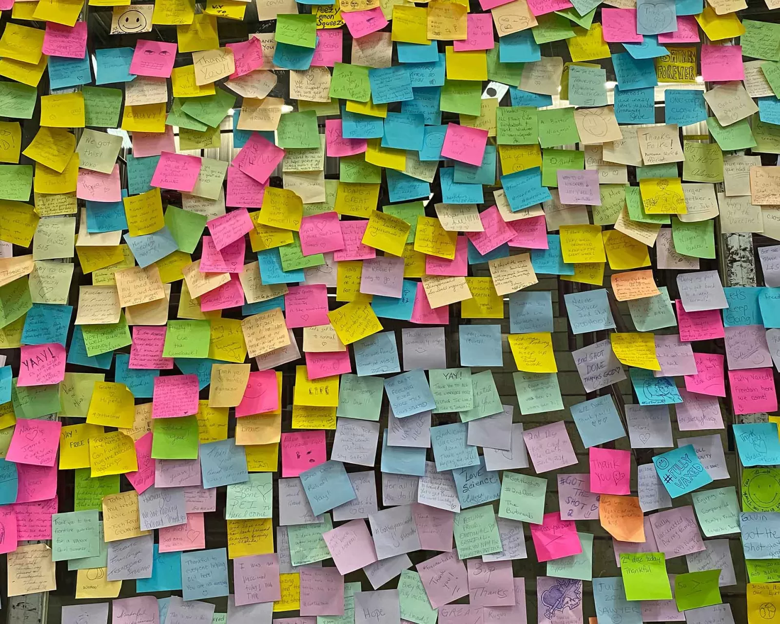 Parete ricoperta di post-it colorati, metafora dei diversi significati nascosti dietro le parole e le obiezioni nel marketing